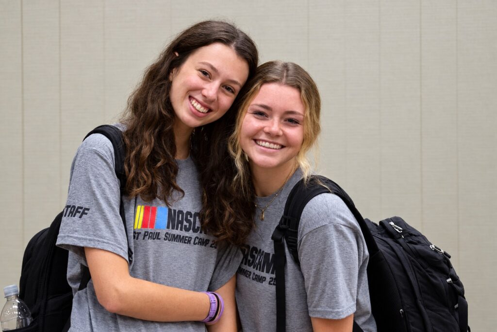 Two St Paul young adults smiling together at summer camp